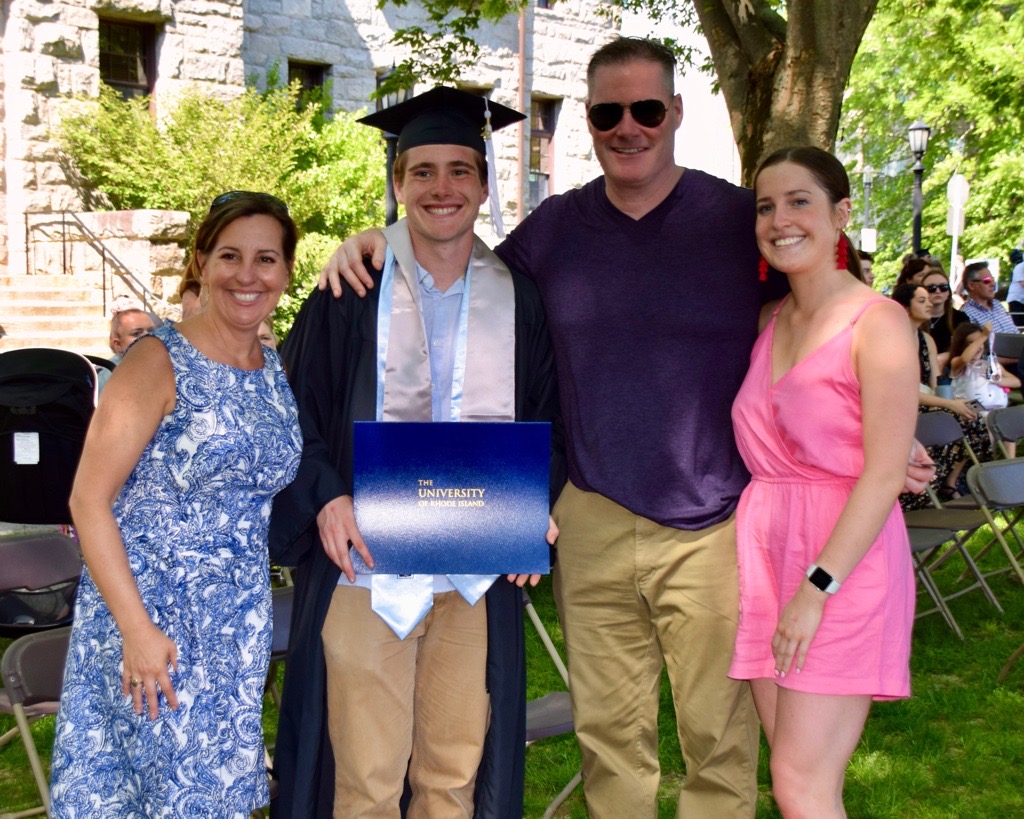 Jack posing for a photo with his family after graduation